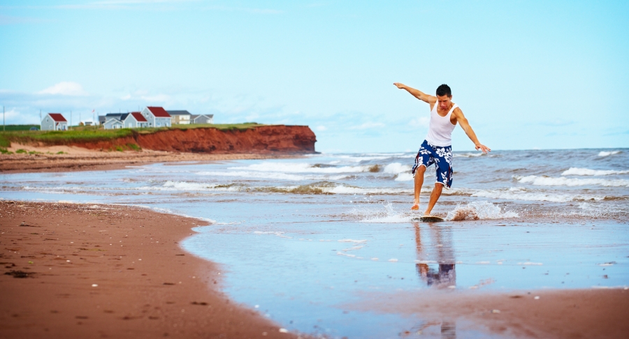 Skimboard surfing, red sand, beach