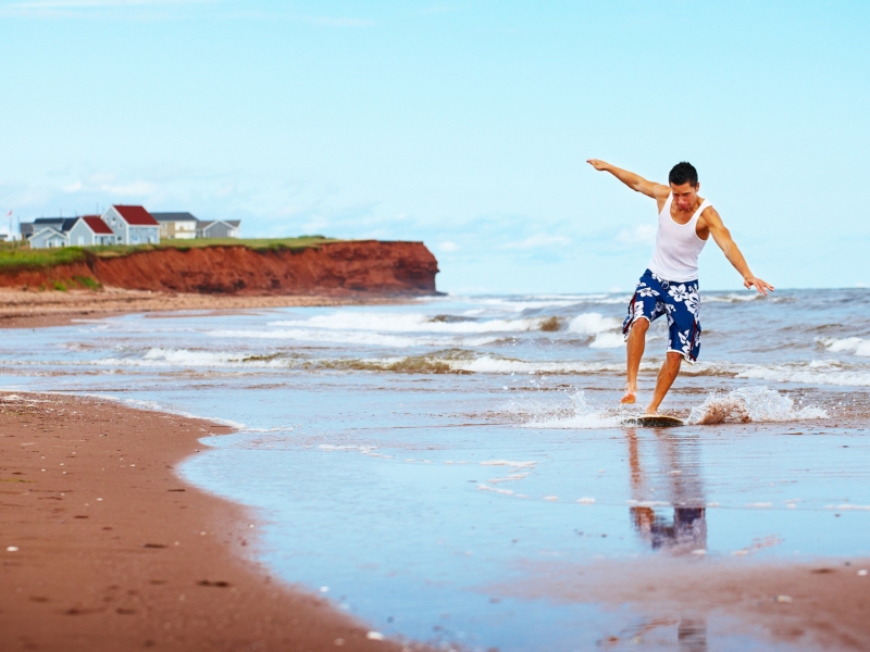 Skimboard surfing, red sand, beach