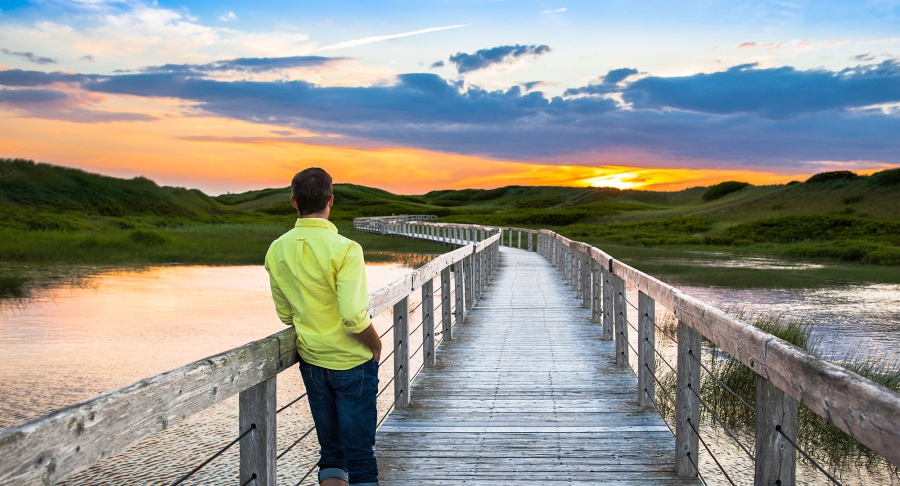 Man standing on Greenwich Boardwalk Sunset