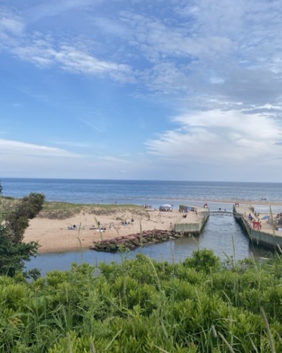 View of channel at Basin Head Provincial Park under blue sky