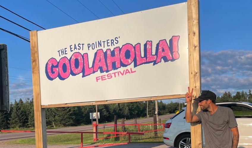 Tim Chaisson standing next to venue sign for Goolaholla!