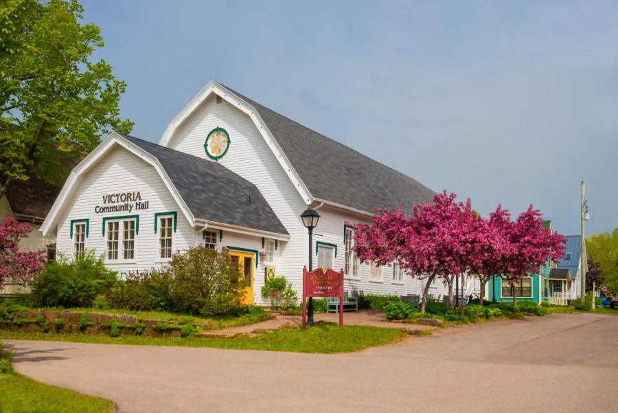 outside view of the Victoria Playhouse. beautiful white structure with blooming cherry trees outside.